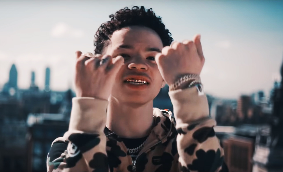 lil-mosey-wearing-bape-camo-hoody-gold-teeth-kamikaze-music-video-wing-ring-cuban-link-chains
